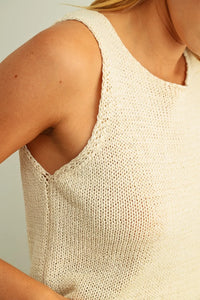 A soft off-white sleeveless roundneck knitted top with relaxed fit and open shoulder detail