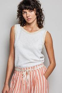 A soft off-white boho textured rib tank top with delicate lace trim along the neckline rib tank style