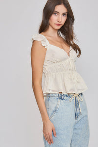 A soft off-white embroidered ruffle sleeve blouse with a gathered bodice and delicate shoulder straps