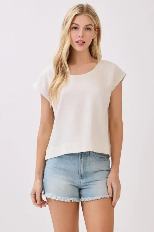 A soft off-white extended sleeve boxy top with loose fit and short slightly flared sleeves for casual wear