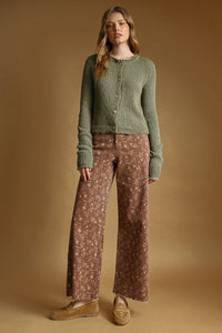 A soft olive green sweater knit cardigan with button front and ribbed cuffs made of knitted fabric