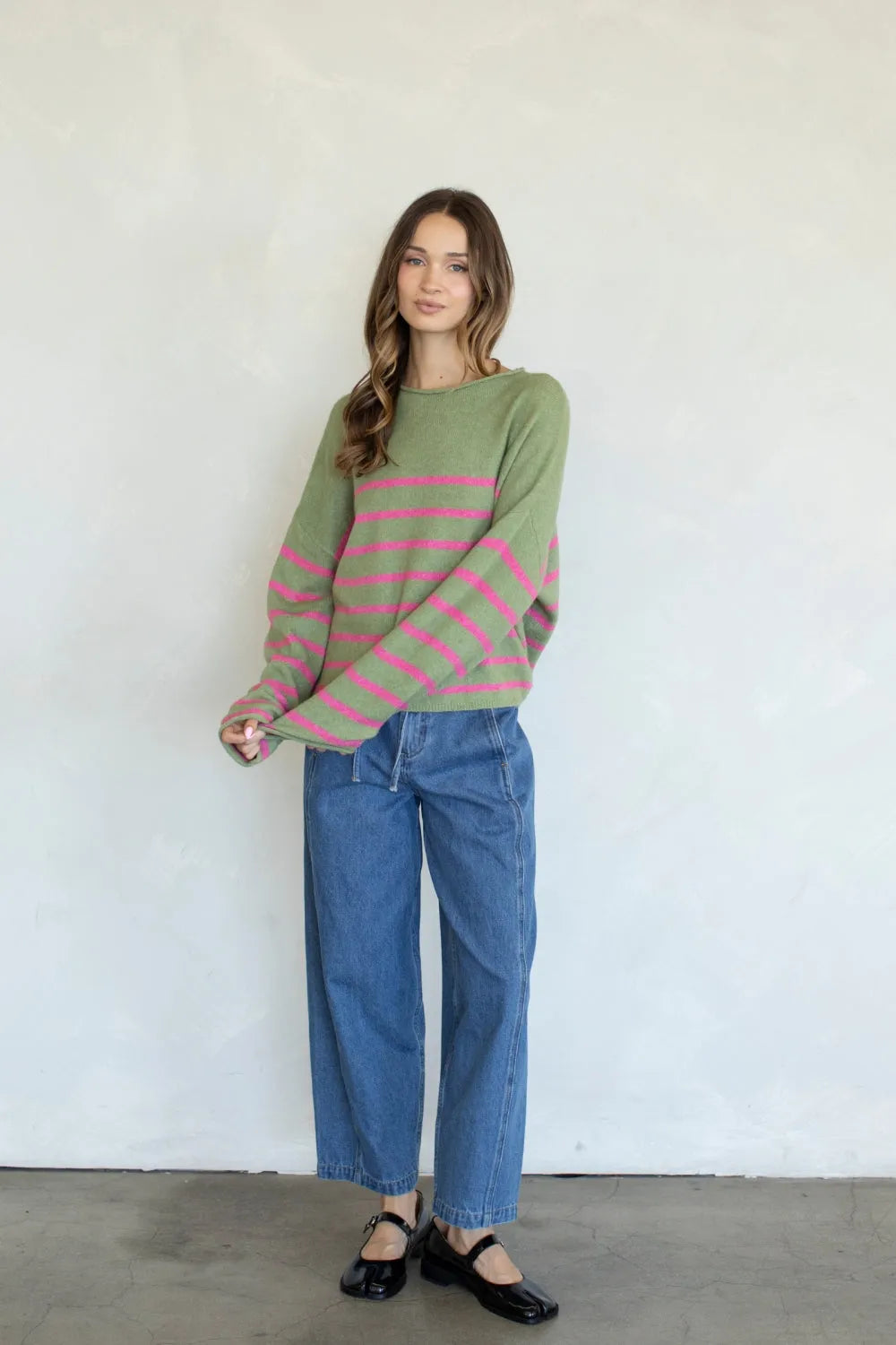 A soft olive green and pink striped knit quarter stripe piper pullover sweater with long sleeves
