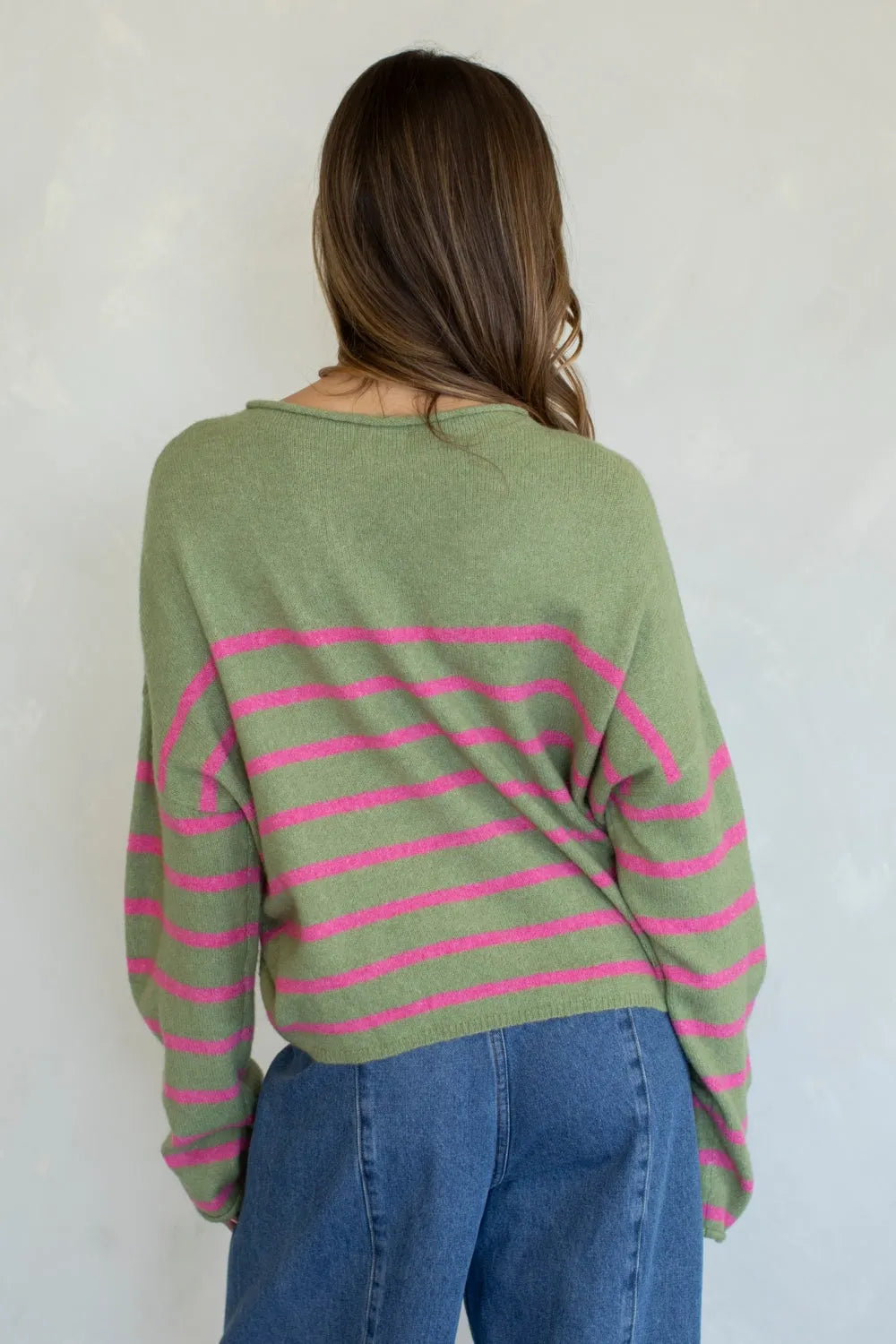 A soft olive green and vibrant pink quarter stripe piper pullover sweater in a relaxed oversized knit fit