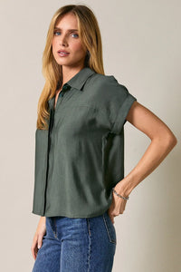 A soft olive-green collard wide shoulder button short-sleeved blouse with relaxed fit and front pleats