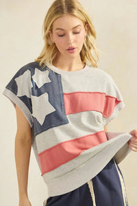 A soft oversized american flag patch mineral wash sweatshirt in faded navy blue and coral pink stripes with white stars