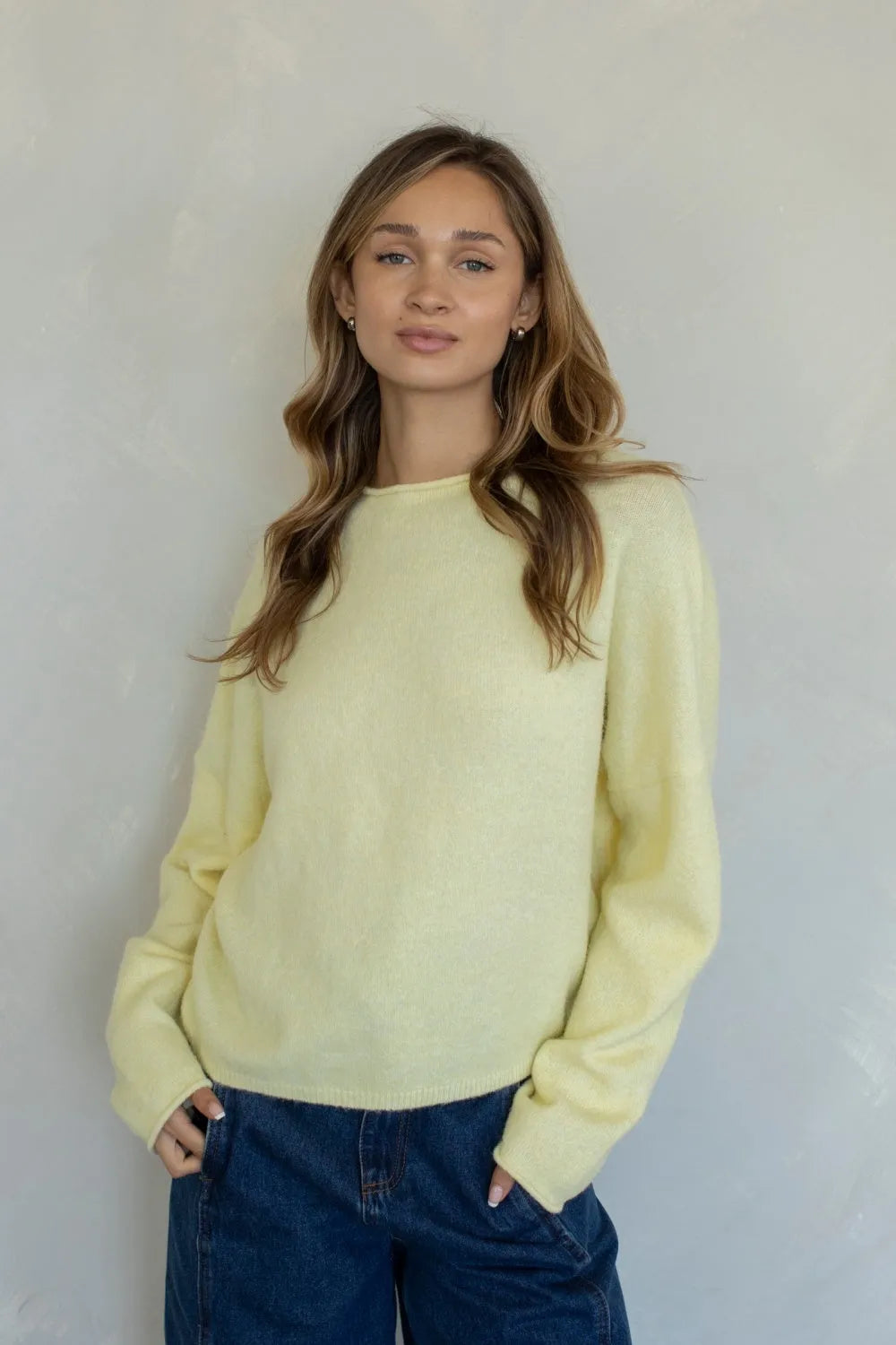 A soft pale yellow oversized soft piper pullover sweater with long sleeves and relaxed fit knit design
