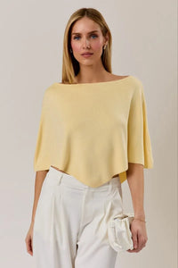 A soft pale yellow poncho knit top with a slouchy neck line and short flutter sleeves in a relaxed fit