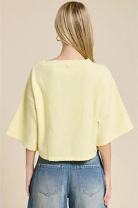 A soft pale yellow wide sleeve button front cardigan in knit fabric with wide sleeves and a ribbed neckline