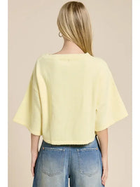 A soft pale yellow wide sleeve button front cardigan with bell-shaped sleeves and a ribbed neckline