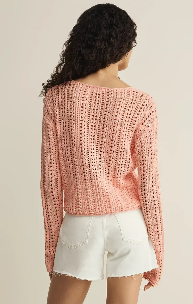 A soft pink long-sleeved knitted upland crochet sweater with a textured openwork pattern