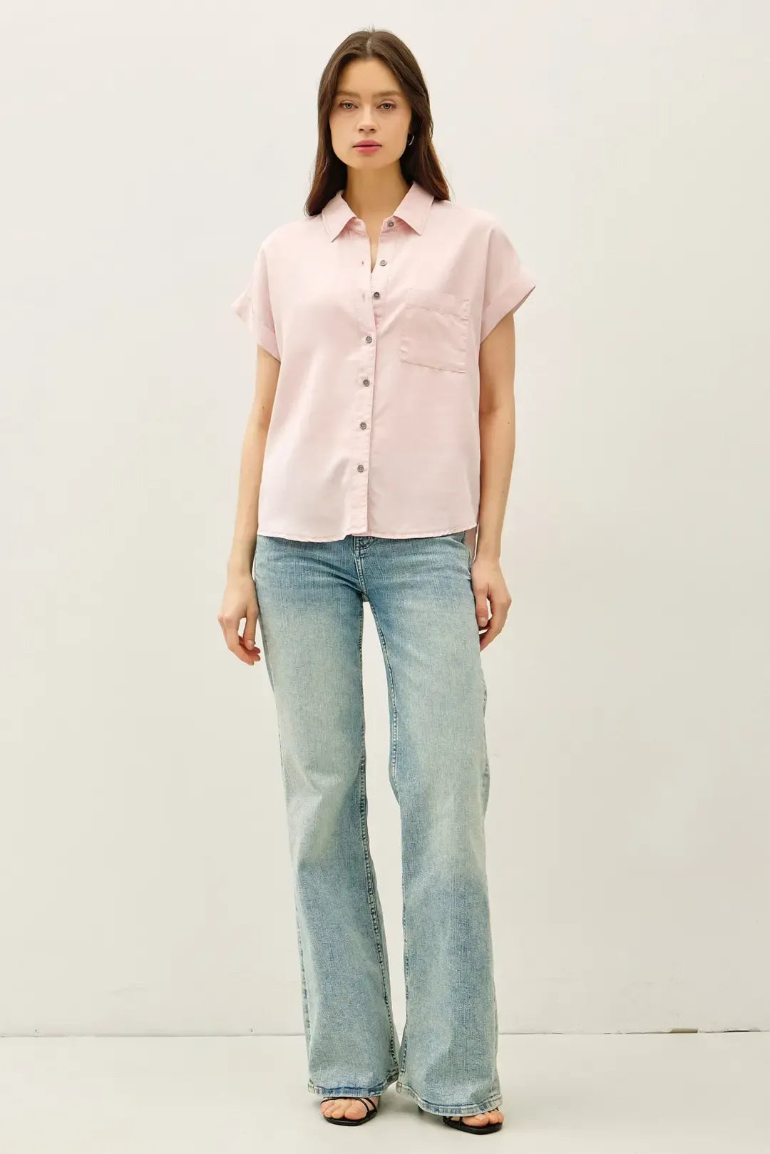 A soft pink short dolman sleeve button shirt with classic collar and front pocket for casual wear