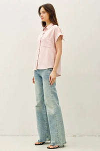 A soft pink short dolman sleeve button shirt with subtle left pocket and short sleeves for casual wear
