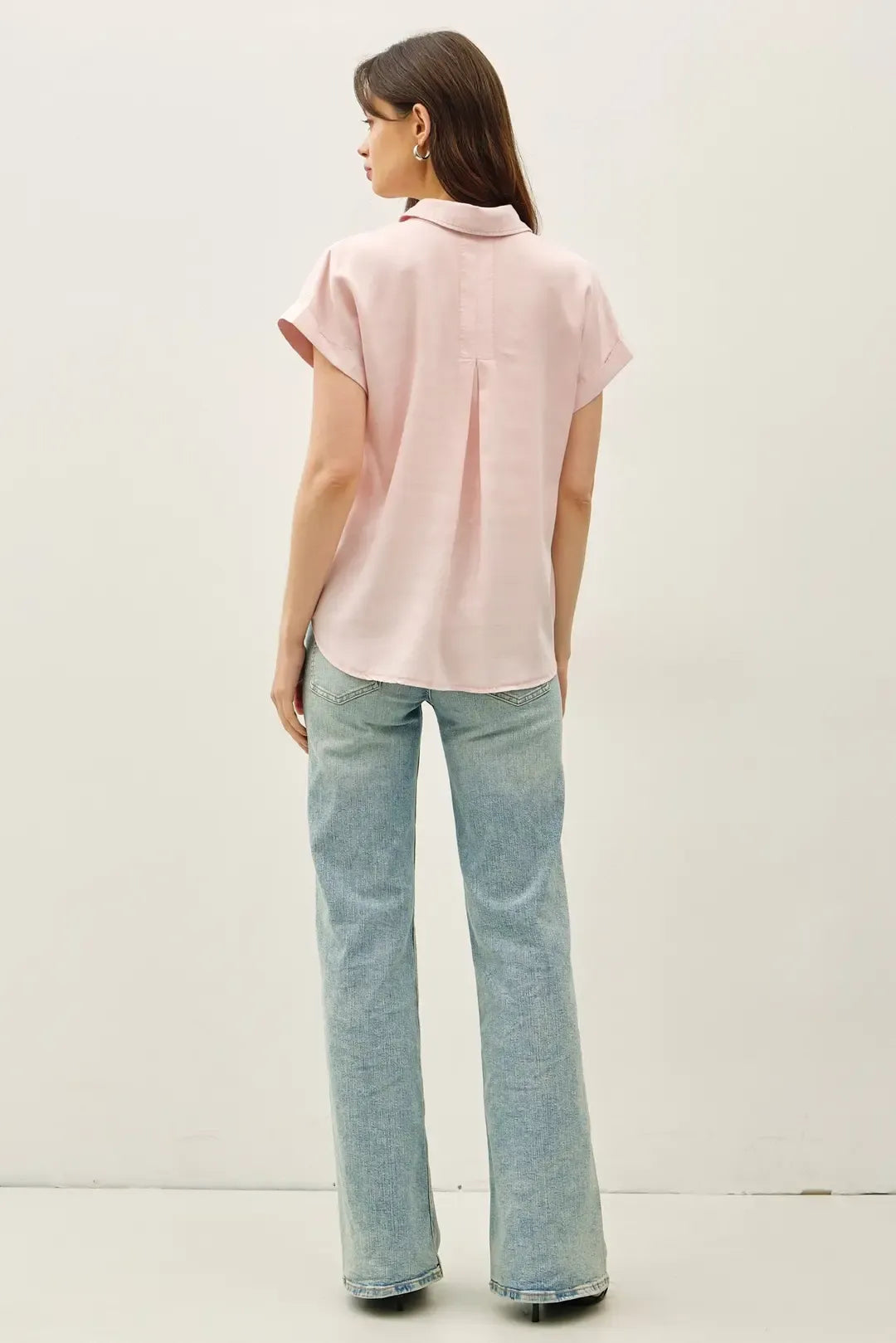 A soft pink short dolman sleeve button down shirt with classic collar and subtle pleats at the back