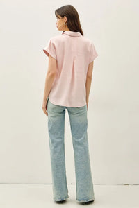 A soft pink short dolman sleeve button down shirt with classic collar and subtle pleats at the back