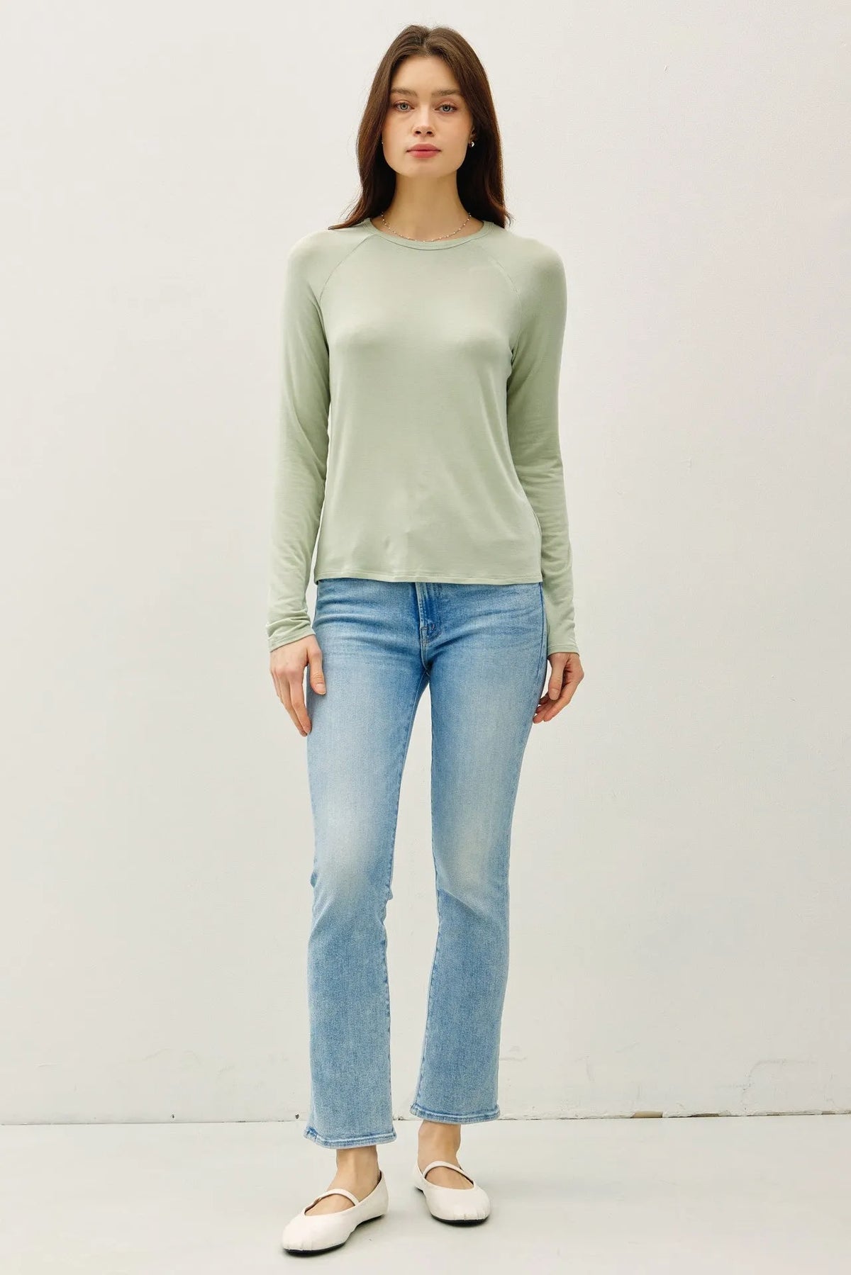 A soft sage green modal raglan sleeve layering basic top with long sleeves, round neckline, and ribbed cuffs