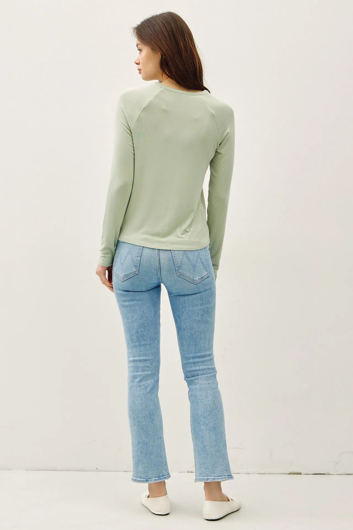 A soft sage green modal raglan sleeve layering basic top with long sleeves and a round neckline