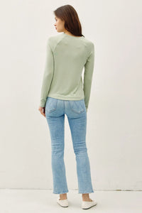 A soft sage green modal raglan sleeve layering basic top with long sleeves and a round neckline