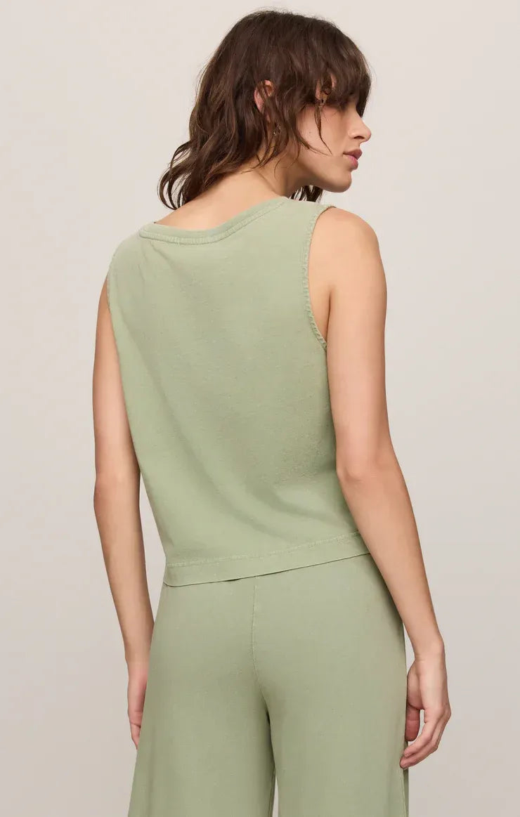 Soft sage green sleeveless cotton jersey tank top with rounded neckline and subtle seam detailing on armholes