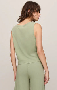 Soft sage green sleeveless cotton jersey tank top with rounded neckline and subtle seam detailing on armholes