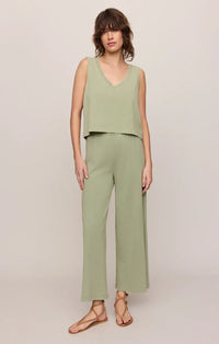 A soft sage green v neck cotton jersey tank top with a relaxed fit paired with matching wide leg trousers