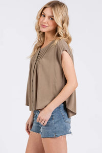 A soft taupe sleeveless blouse with pintuck detailed button front and pleated design for elegant wear