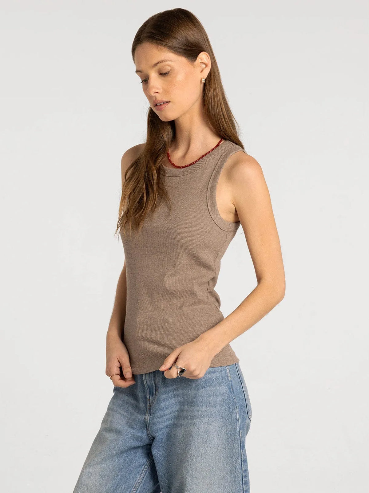 A soft taupe ribbed knit sleeveless edlin basic tank with rounded neckline and subtle seam detailing by thread and supply