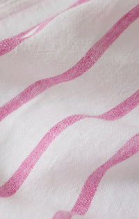 The perfect linen striped top features soft white fabric with delicate pink wavy stripes in linen striped design