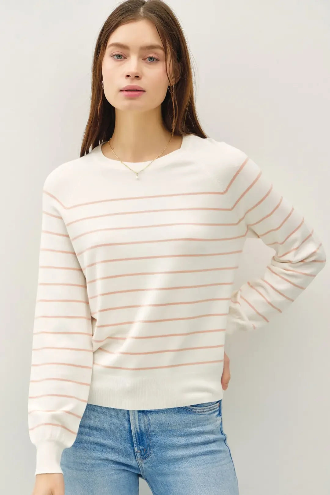 Lightweight striped long sleeve sweater in soft white with peach stripes