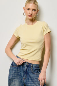 A soft yellow fitted crewneck baby tee with short sleeves and a round neckline in cropped style