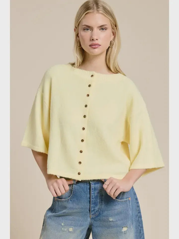 A soft yellow wide sleeve button front cardigan knit top with loose fit and front button closure