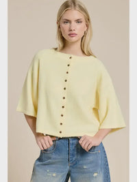A soft yellow wide sleeve button front cardigan knit top with loose fit and front button closure