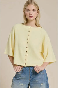 A soft yellow wide sleeve button front cardigan made of knit fabric with loose fitting and wide sleeves