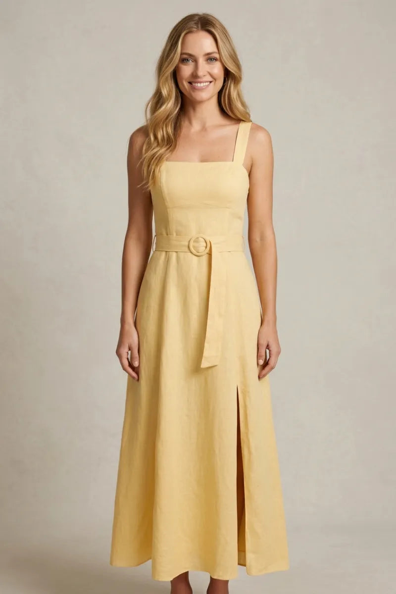 A soft yellow linen square neck midi dress with thin straps and a matching belt featuring a circular buckle