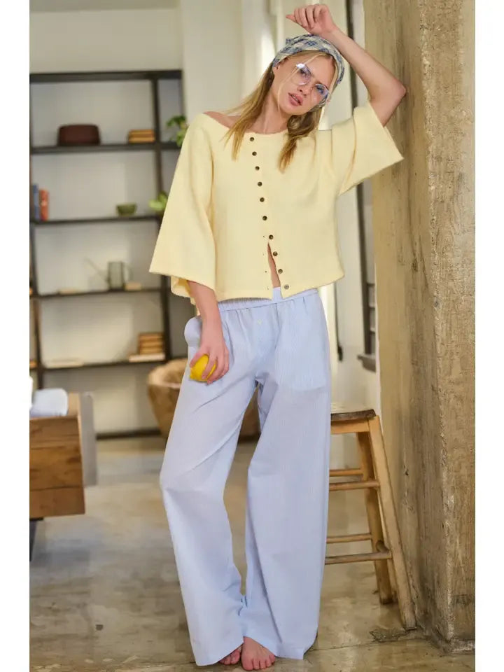 A soft yellow wide sleeve button front cardigan with off-the-shoulder cropped top and button detailing
