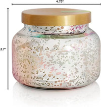 A mercury iridescent candle in a speckled glass jar with a gold lid featuring soft pink and metallic gradient hues