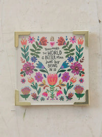 A square decorative corner magnet with a vibrant floral design and inspirational script on a white background