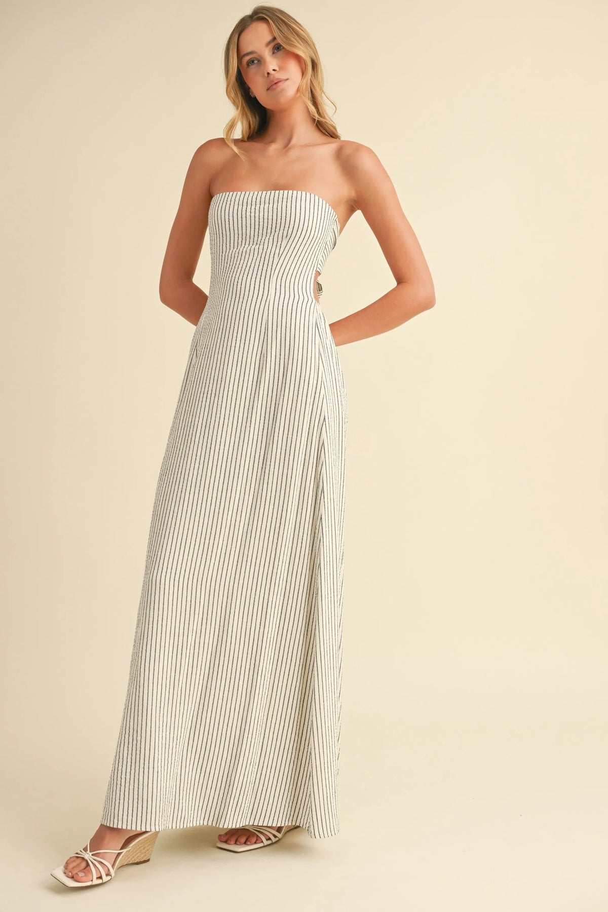 Cream and navy blue vertical striped tie strapless maxi dress with a long back tie detail and floor-length design