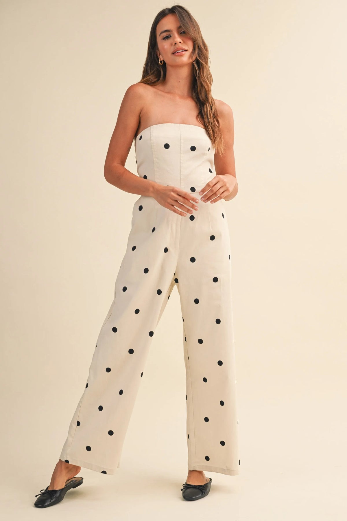 Off-white strapless polka dot stretch twill jumpsuit with fitted bodice and wide leg design