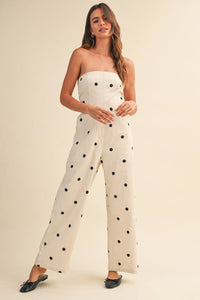 Off-white strapless polka dot stretch twill jumpsuit with fitted bodice and wide leg design