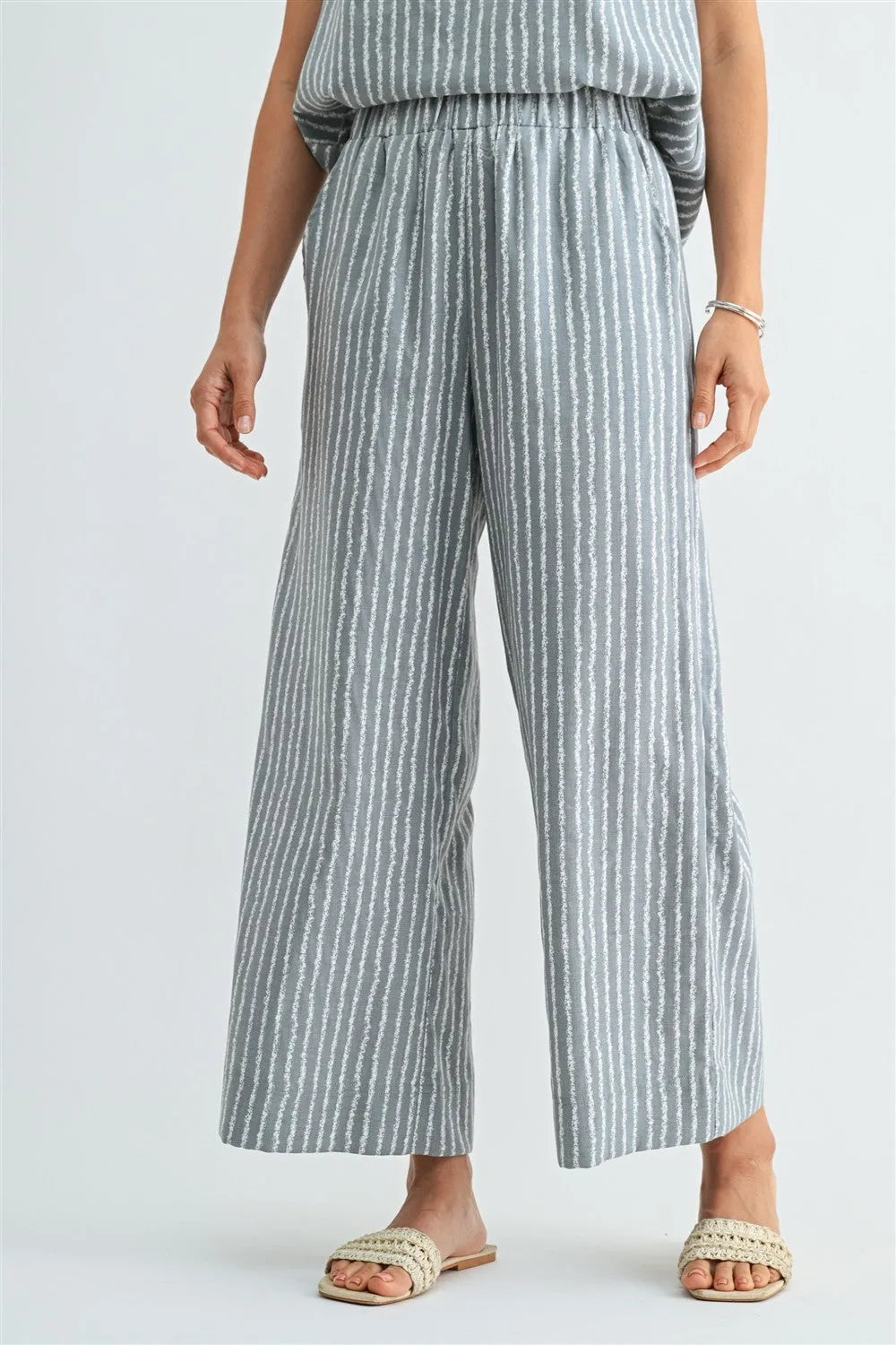 Light blue and white stripe straight leg elastic pants made of soft flowing fabric with a wide leg design