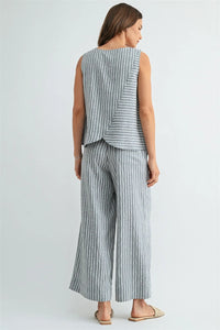 A sleeveless gray and white vertically striped top with a layered asymmetrical hem paired with stripe straight leg elastic pants
