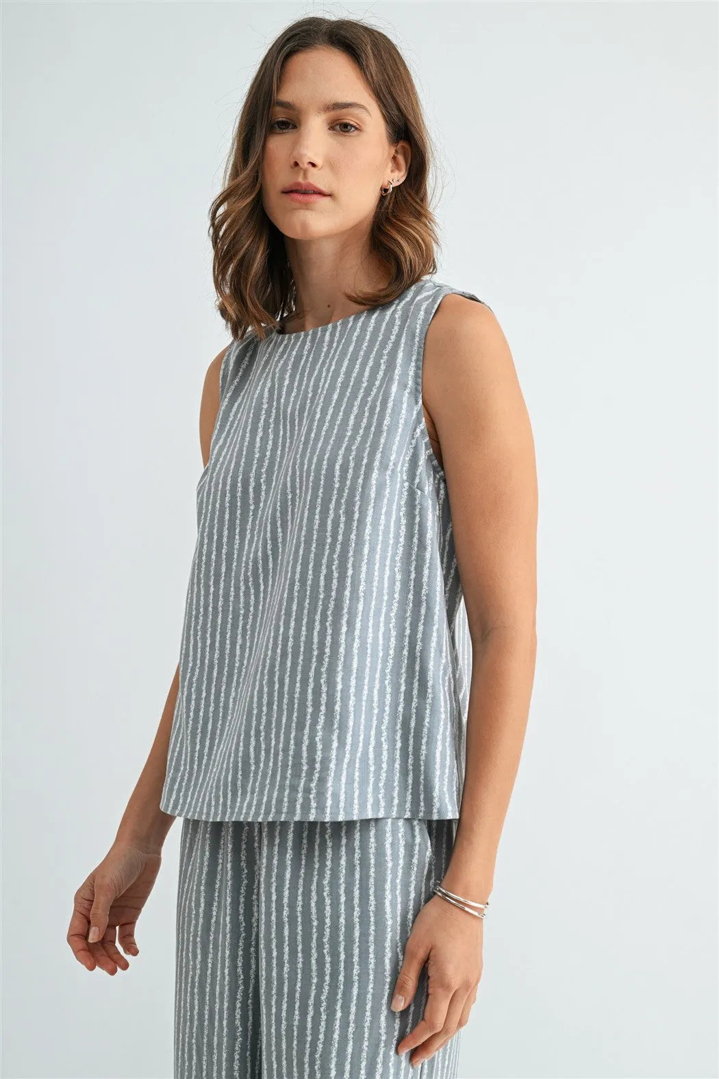 Stripe with side details sleeveless top in soft gray with white vertical stripes made of lightweight fabric for women’s boho chic clothing from shop daisy