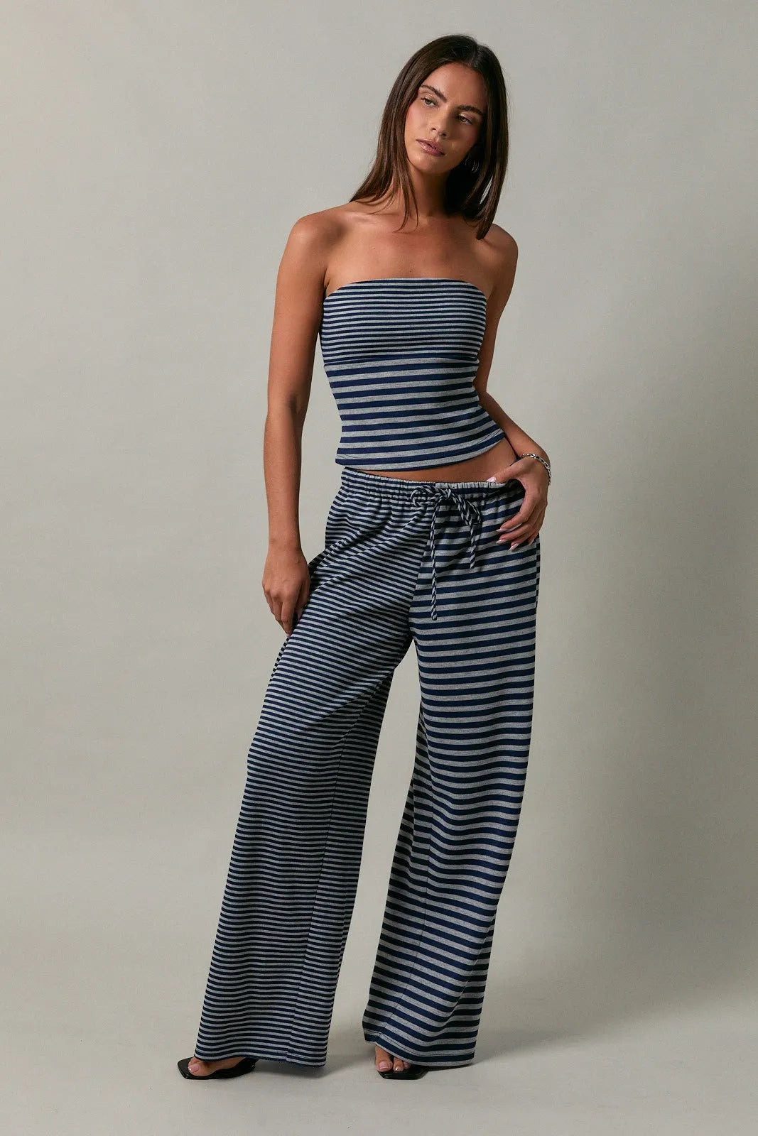 Low rise stripe front tie pants featuring striped navy and white wide-leg fabric with a drawstring waist