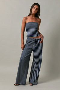 Low rise stripe front tie pants featuring striped navy and white wide-leg fabric with a drawstring waist