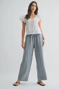 Striped wide leg drawstring pants in soft blue and white vertical stripes made from lightweight fabric with a relaxed fit