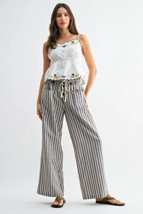 Striped wide leg linen blend pants in soft gray and white with vertical stripes, drawstring waist, and side pockets