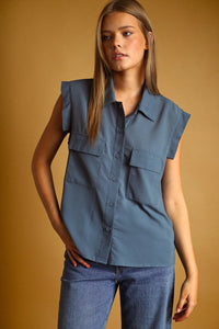 A stylish blue sleeveless chiffon blouse with ruffled shoulders and front patch pockets featuring pocket button details