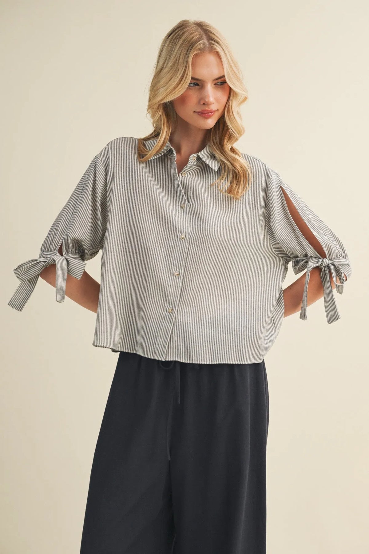A stylish gray and white striped tie cuff button front top with short tied sleeves for casual wear