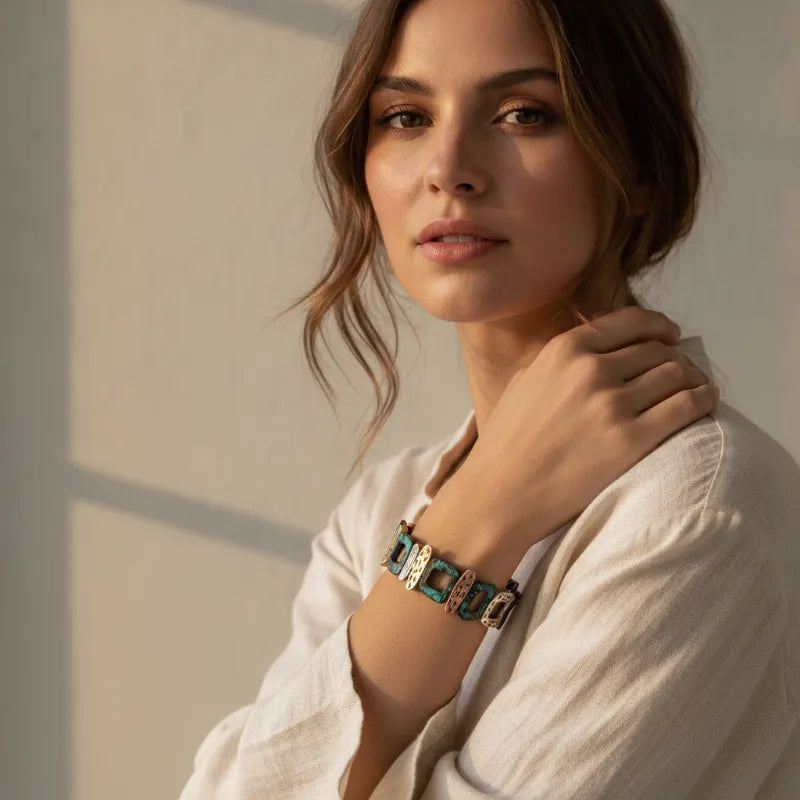 A stylish turquoise and silver-toned patina geometric stretch bracelet with a modern link design worn on the wrist