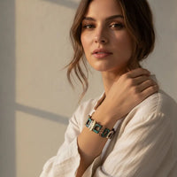 A stylish turquoise and silver-toned patina geometric stretch bracelet with a modern link design worn on the wrist